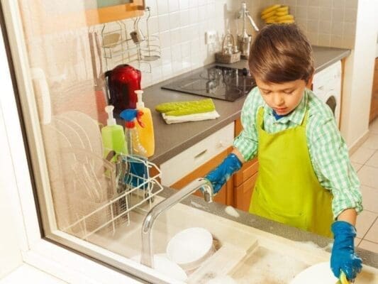 Boy doing dishes